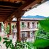 La Ermita de Santa Lucia in Antigua, covered corridor with balconies, courtyard, and mountain view