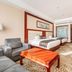 Long Fei Sheng Shi International Hotel in Yan’an, guest room with two beds, sofa, and desk
