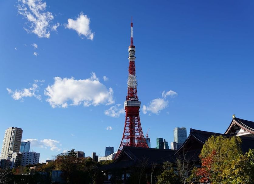 Tosei Hotel Cocone Kanda in Tokyo with Tokyo Tower above city buildings and a traditional rooftop