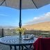 Dolgun Uchaf Guesthouse in Dolgellau patio table under umbrella with mountain and valley views