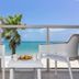 Ocean Breeze Inn Vero Beach balcony with chairs, table, and ocean view in Vero Beach