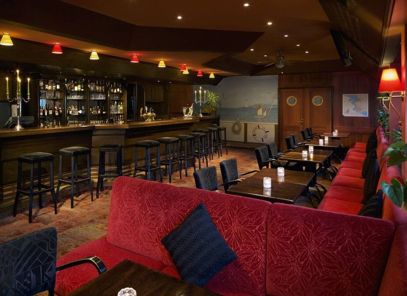 Hotel Parc Belle-Vue bar and lounge in Luxembourg with stools, tables, and red seating