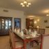 Siji Hotel Apartments in Fujairah dining room with set table, cabinet, sofa seating and chandeliers