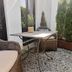 Country-Suites By Verdino Living - Apartments & Privatzimmer in Braunlage, wicker patio seating and table in a gravel courtyard