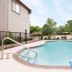 Hotel Piney Woods Huntsville outdoor pool with blue lounge chair and trees