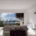 Rhenia Hotel in Tourlos with sea view through a bright lounge and white seating