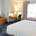 Fairfield Inn & Suites by Marriott Indianapolis East guest room with bed, desk, TV and window