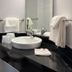 Motel 6-Joliet, IL - Chicago - I-55 bathroom with black vanity, sink, mirror, and towels