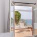Rhenia Hotel in Tourlos room opens to terrace with sea and harbor views