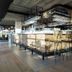 Strandhotel Vigilante in Makkum bar area with high stools and glassware under hanging lights