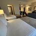 Best Western Plus Chihuahua Juventud guest room with two beds, seating area, desk and TV in Chihuahua
