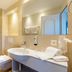 Hotel Kreuz by bsmart Sachseln bathroom with walk-in shower, sink and wall-mounted toilet