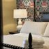 Maxwelton Braes Lodge in Baileys Harbor guest room with bed, folded towels, lamp and floral wallpaper