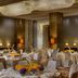 Four Seasons Hotel Shenzhen banquet hall with round tables, floral centerpieces and chandeliers