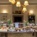 Hotel Massimo in Cecina breakfast buffet setup in a dining room with tables and chandeliers