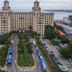 Aht Colonial Hostel in Havana with twin towers, oceanfront views, and a pool beside palm-lined grounds