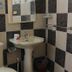 La Isla Bonita Resort, Boracay bathroom with pedestal sink, toilet, shower curtain, and checkered tile walls