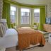 Hotel du Vin Henley guest room with bay windows, green curtains, fireplace and TV in Henley-on-Thames