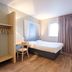 B&B HOTEL Calais Centre St Pierre guest room with single bed, desk chair, wardrobe and window in Calais