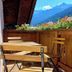 Dorf.Apart in Neustift im Stubaital terrace with wooden table, chairs and mountain views