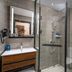 Hanting Hotel Dongguan Changan Wanda bathroom with glass shower, vanity and toilet in Dongguan