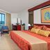 Melia Santiago De Cuba guest room with balcony view over Santiago de Cuba and two armchairs