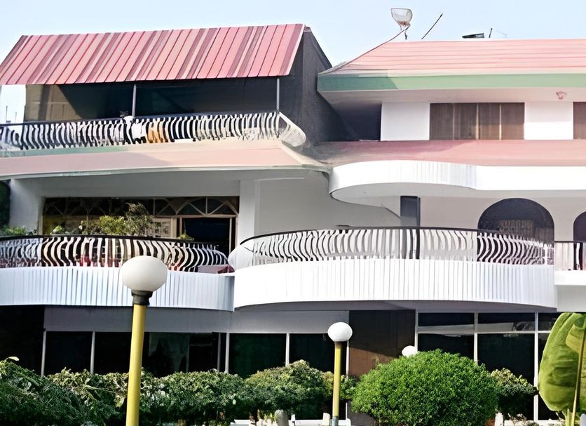Hotel Buddha International in Bodh Gaya with curved balconies and red-roofed exterior