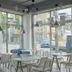 Pohang Youngildae Guesthouse dining area with large windows and city street view in Pohang