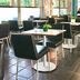 ibis budget Wroclaw Stadion dining area with black chairs and square tables in Wrocław