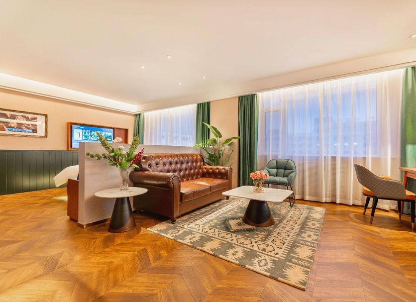 James Joyce Coffetel Hotel Qinhuangdao lobby lounge with sofa, chairs and large windows