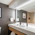 Sheraton Nashville Brentwood bathroom vanity with large mirror and wall sconces in Brentwood