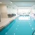 Indoor pool at Hampton Inn By Hilton Elliot Lake in Elliot Lake with lounge chairs and large windows