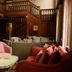 Bartley Lodge Hotel in Southampton lounge with wood paneling, pink armchairs and red sofas