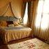 Elif Hatun Konagi in Tarsus, elegant hotel bedroom with canopy bed and large sunlit windows