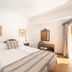 allsun Hotel Paguera Vera Beach in Peguera: bright double room with striped bedspread and desk