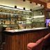 Jullundur Hotel & Restaurant in Chandigarh bar with backlit liquor shelves and pink upholstered stools