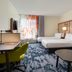 Fairfield Inn & Suites by Marriott Fairfield Napa Valley Area guest room with two beds, desk, and sofa