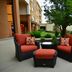 Courtyard by Marriott Kansas City East/Blue Springs outdoor patio with wicker chairs and a tree in Blue Springs