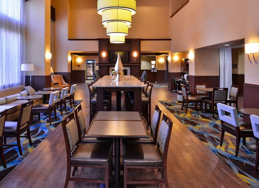 Hampton Inn & Suites Ontario lobby lounge with seating and high tables