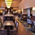 Hampton Inn & Suites Ontario lobby lounge with seating and high tables