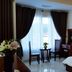 Queen Garden Hotel & Apartment, Vung Tau: guest room with double bed, chairs by window, and city view