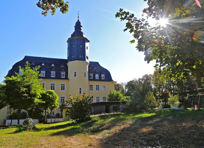 Carea Schlosshotel Domäne Walberberg in Bornheim, exterior view of a castle-style hotel with landscaped grounds
