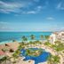 Fiesta Americana Cancun Villas in Cancún with oceanfront pool, palm trees, and Caribbean Sea views