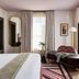 Zelda Dearest Asheville guest room with king bed, chaise lounge, and tall window with curtains