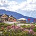 Hotel Alpenkönigin - Alpine Luxury in See with mountain-view terrace and cyclists on a scenic alpine meadow