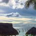 Blue Angel Resort, Cozumel: ocean view with thatched palapas and palm trees at sunset