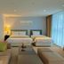 Aventree Hotel Busan guest room with two beds, sofa seating, and floor-to-ceiling window