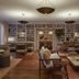 Miiro Borneta Barcelona lounge with bookshelves, sofas, wood floors and a central coffee table