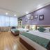East Garden Hotel Chongqing guest room with two beds, sofa, wall-mounted TV and large window
