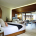 TRS Coral Hotel in Cancún guest room with king bed, sitting area, and balcony view